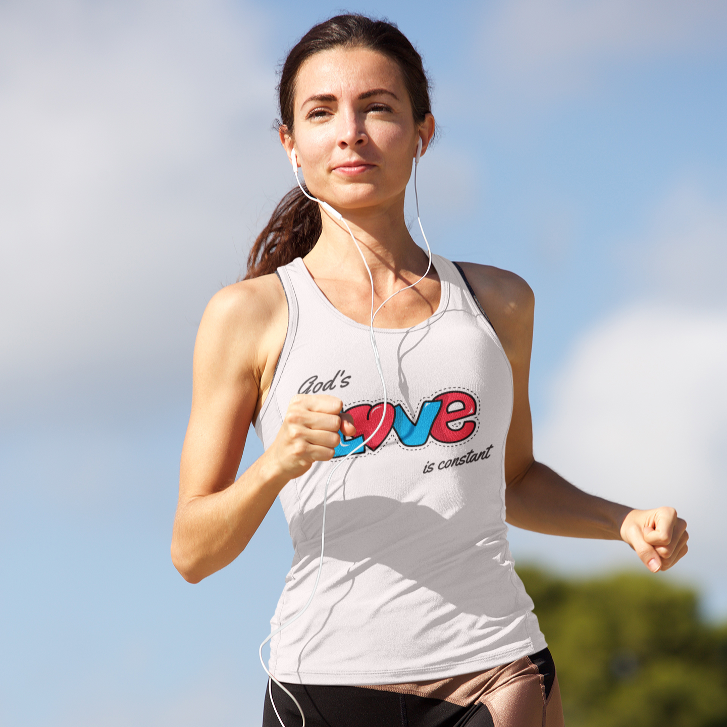 Woman running outdoors in a white tank top with 'God's Love is Constant' text and heart design with a scenic background