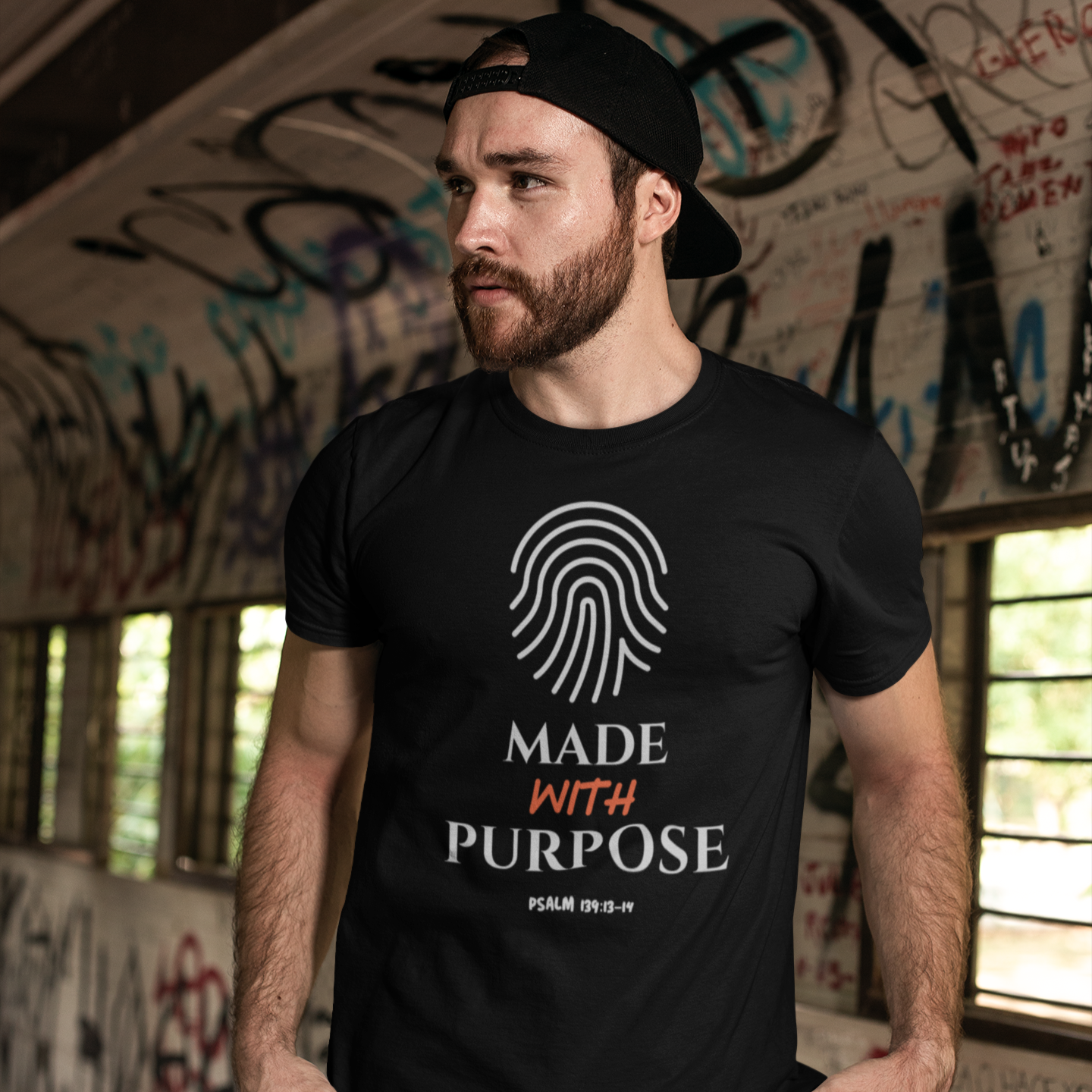 Man wearing a black t-shirt with a fingerprint design and 'Made with Purpose' text