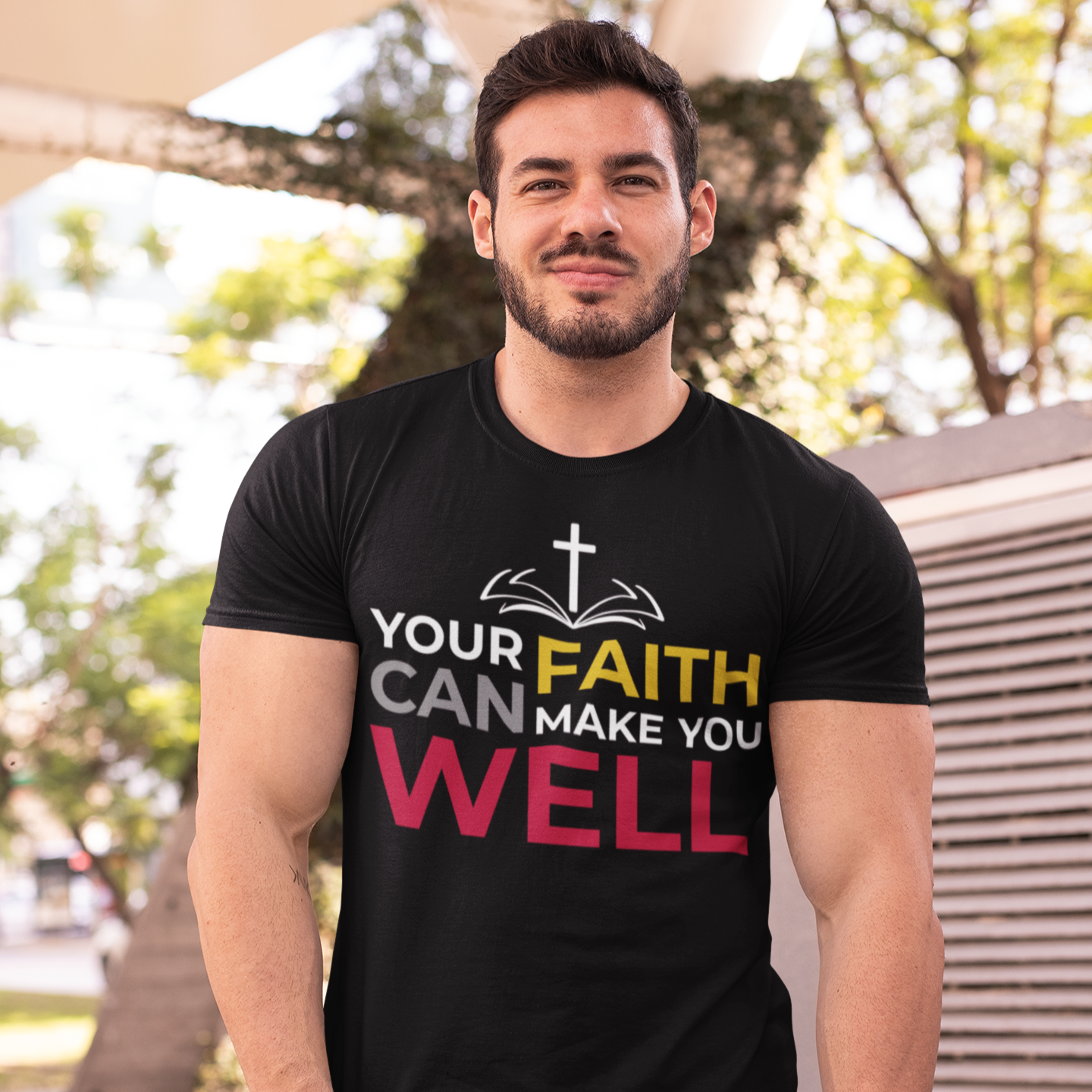 Man wearing a black t-shirt with motivational text that says 'your faith can make you well'.